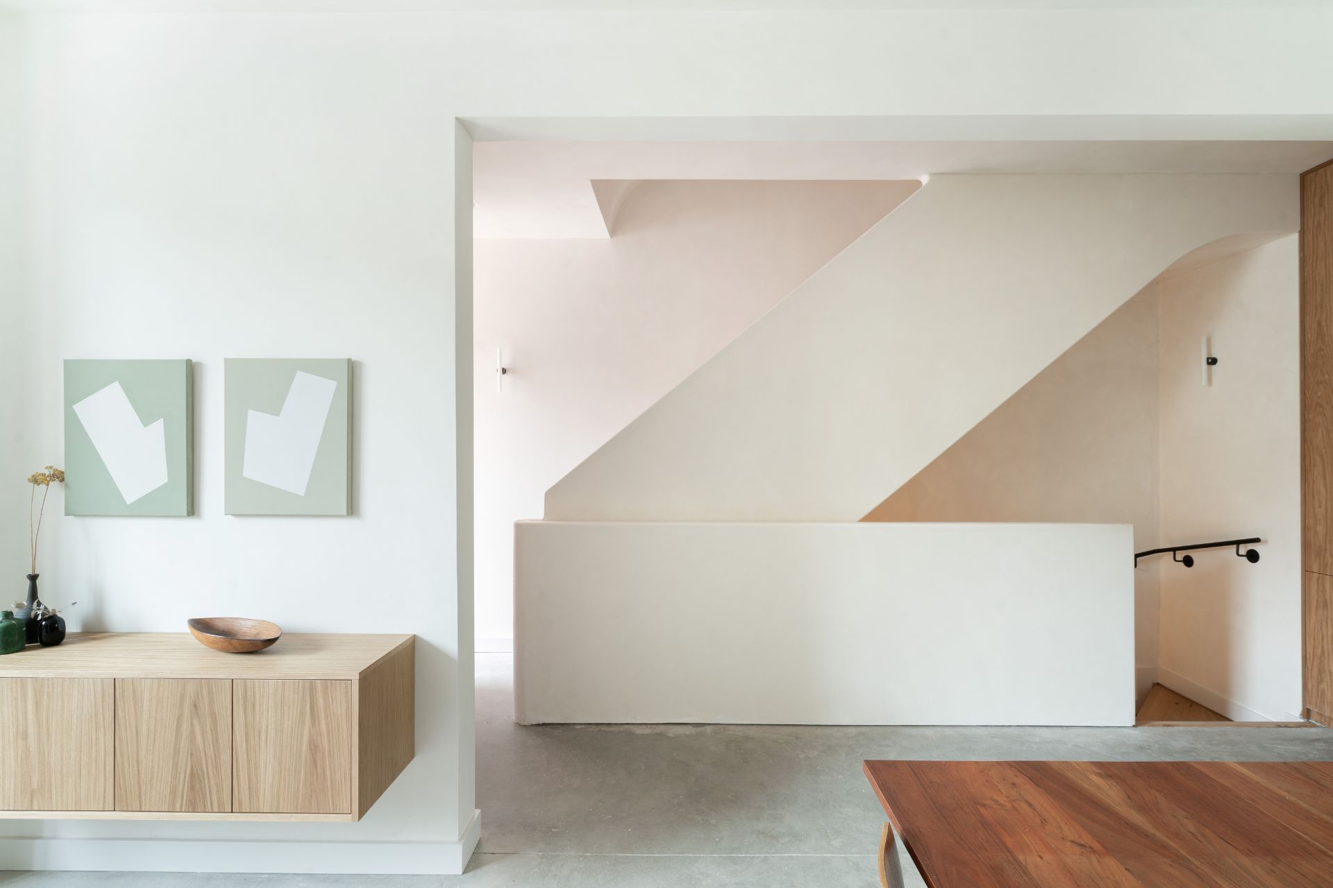 Japandi-style hallway with pale oak console and rich wooden dining table.