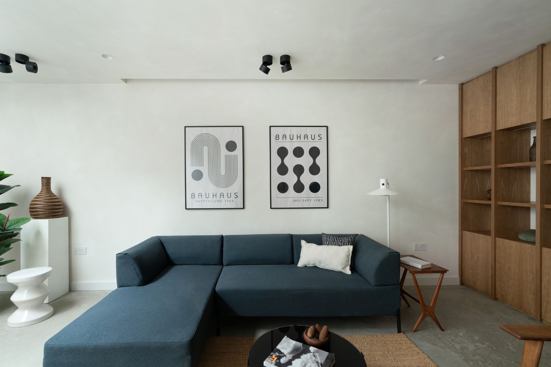 Japandi-style living room with navy corner sofa and dark wooden coffee table