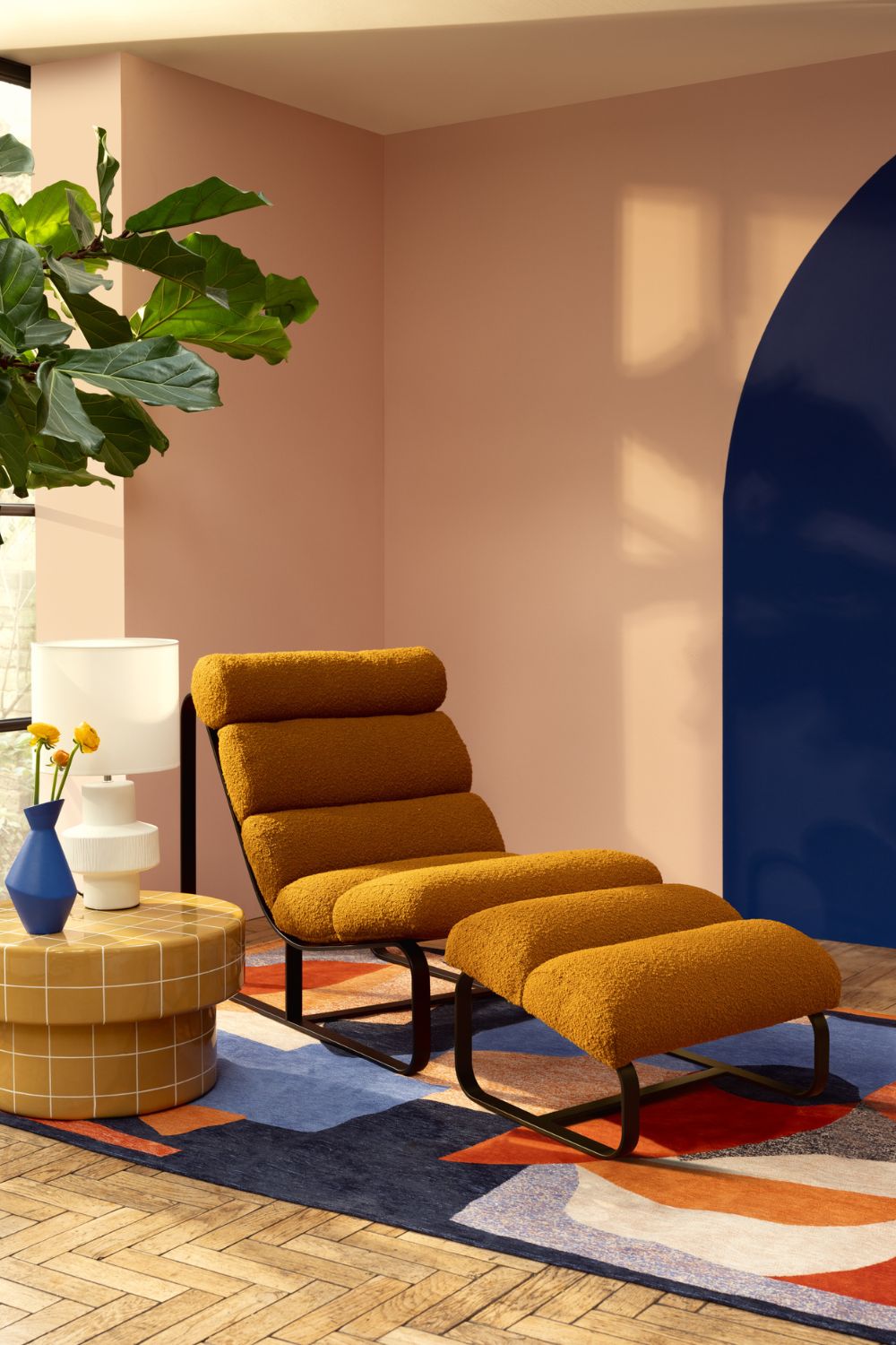 Peach-coloured living room with mustard yellow recliner chair and navy accents