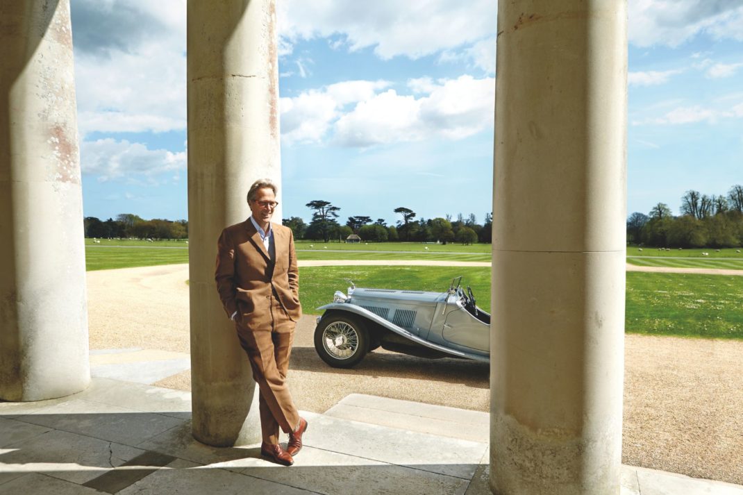 The Duke of Richmond standing beside a classic car