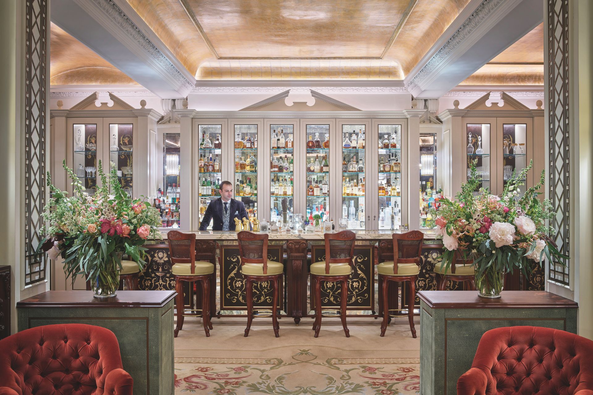 Hotel bar with stained glass backdrop and gilt ceiling