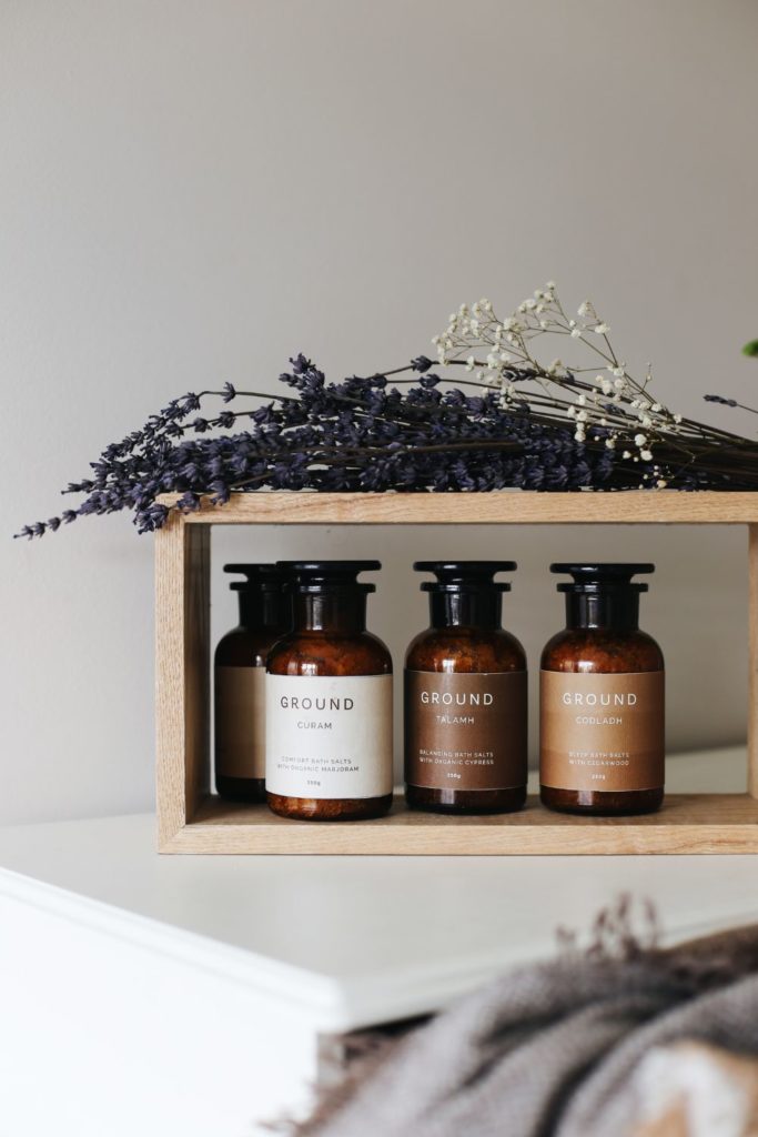 Jars of essential oils on a wooden shelf