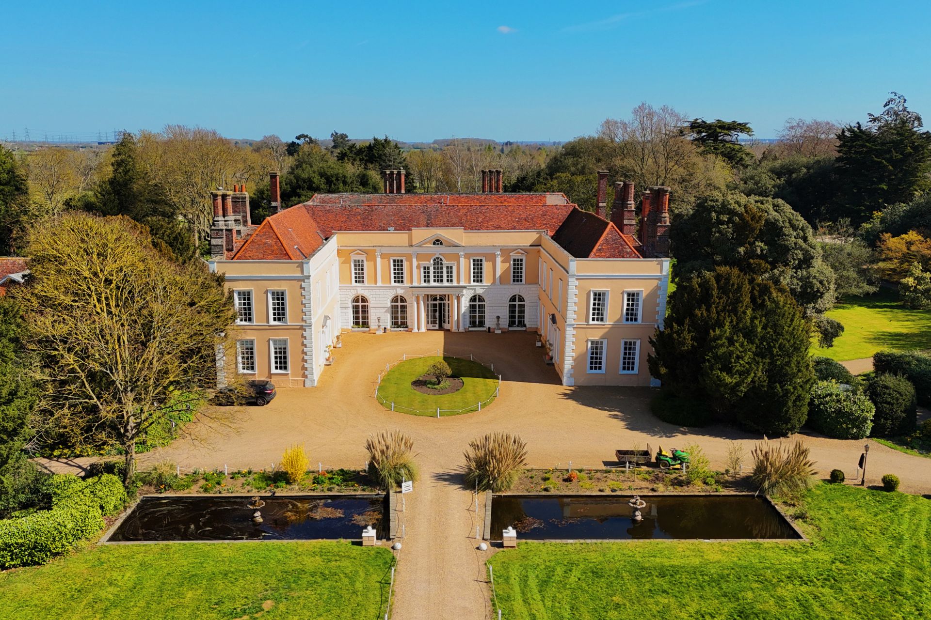 Country manor house with a gravel drive and two ponds
