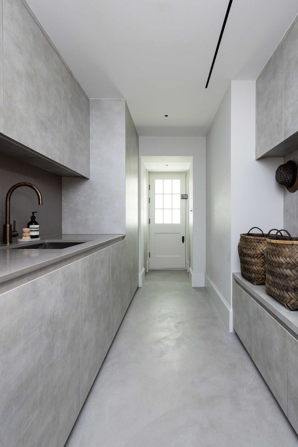 Grey concrete utlity room with black fixtures