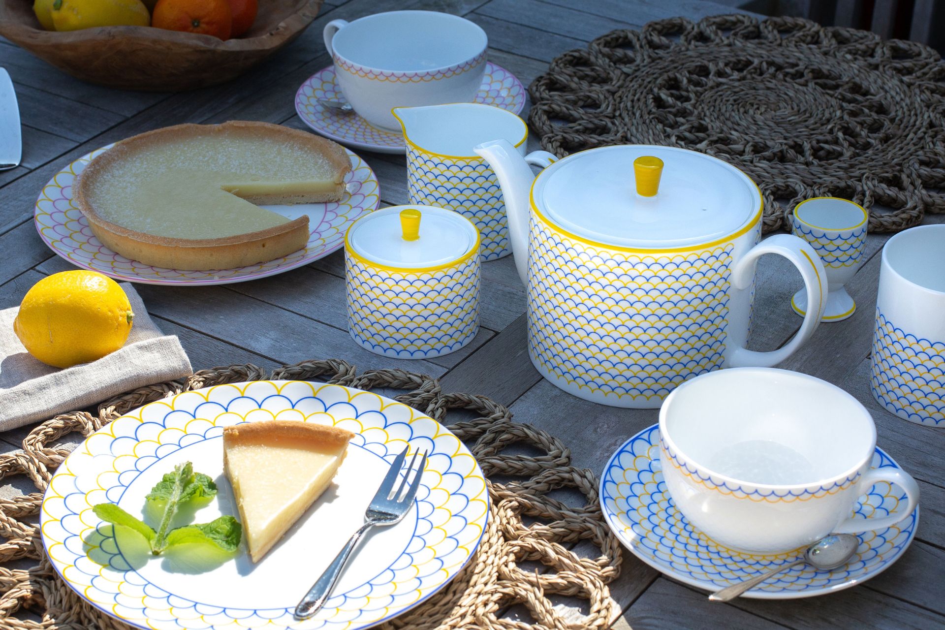 Slice of cheesecake on yellow and blue patterned tableware