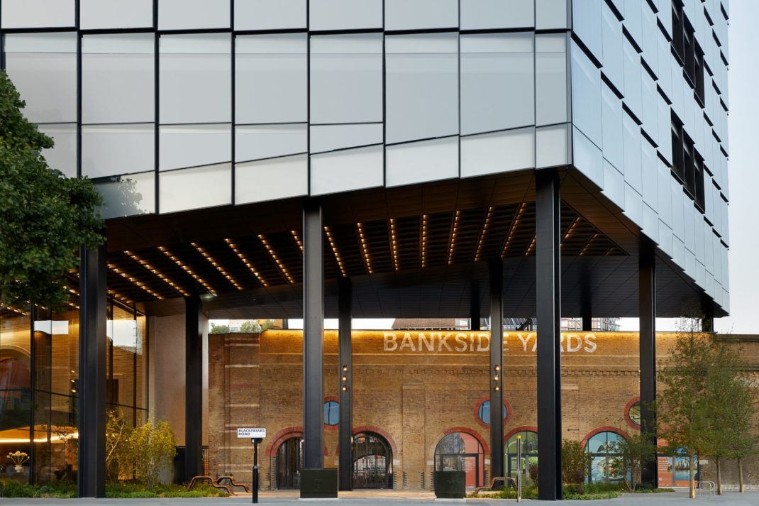 Sleek office building with a triangular facade, above old railway arches in Bankside Yards