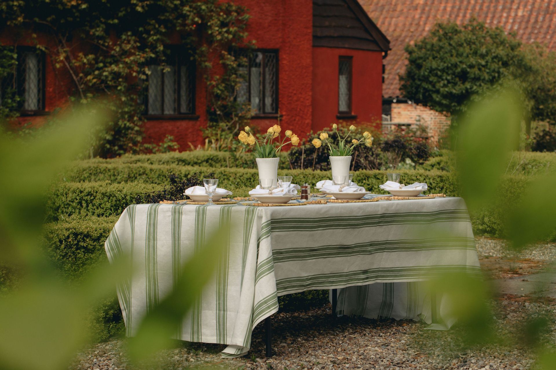 White and green striped tablecloth on garden table