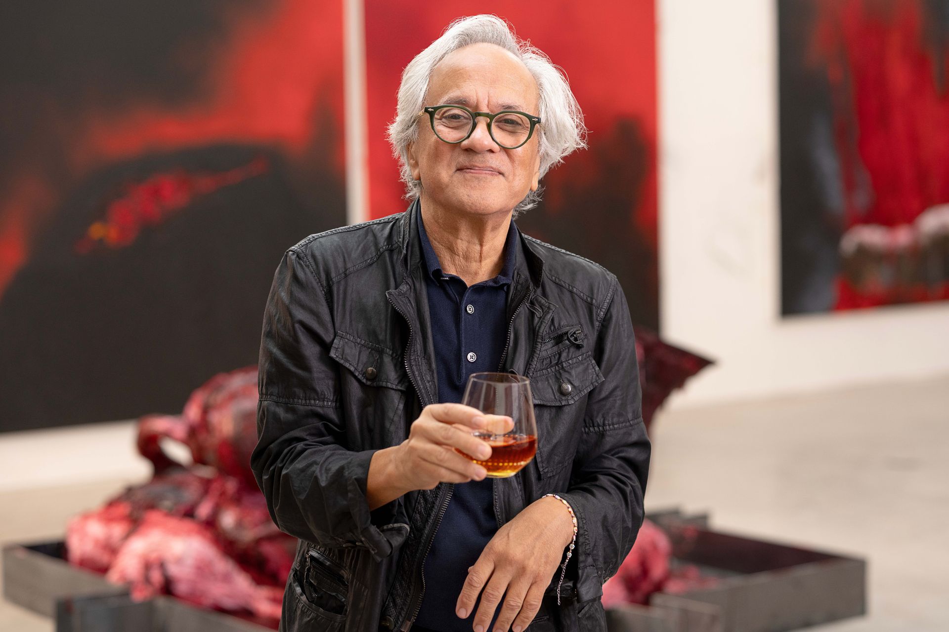 Anish Kapoor holding a glass of his limited edition Remy Martin cognac