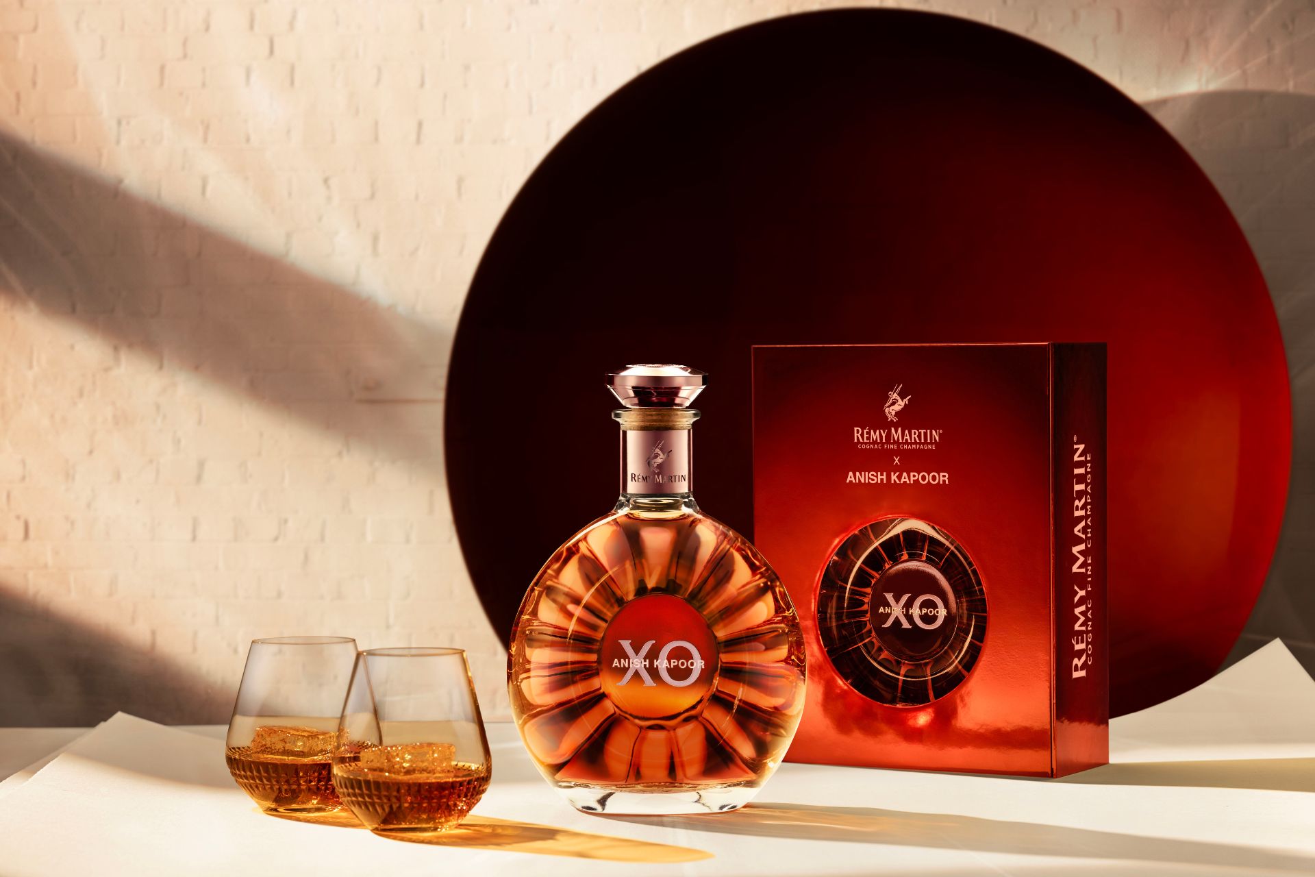 Limited edition bottle of Remy Martin XO with a red box and two crystal glasses