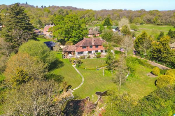 Aerial viewof red brick country home with landscaped gardens