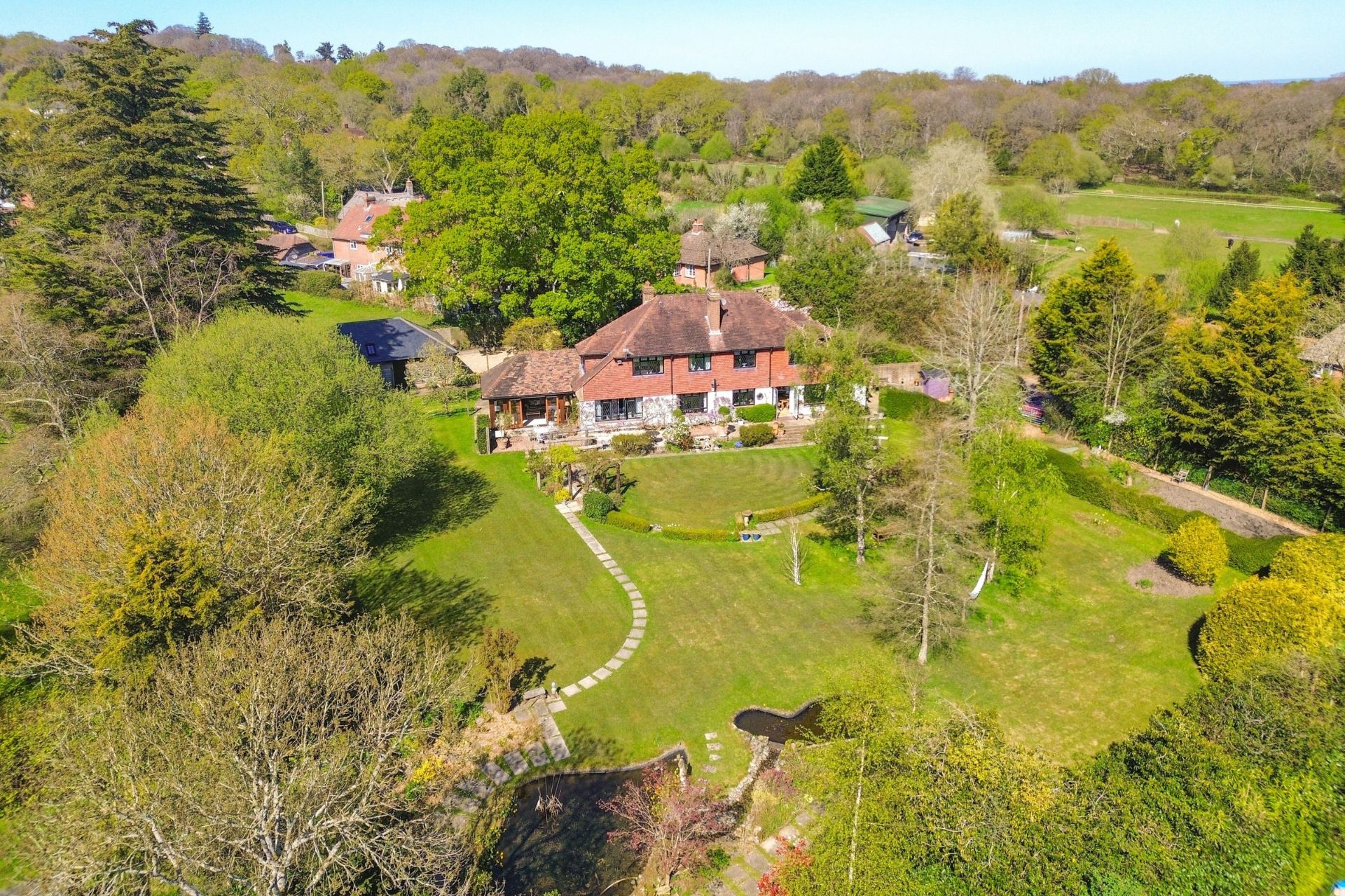 Aerial viewof red brick country home with landscaped gardens