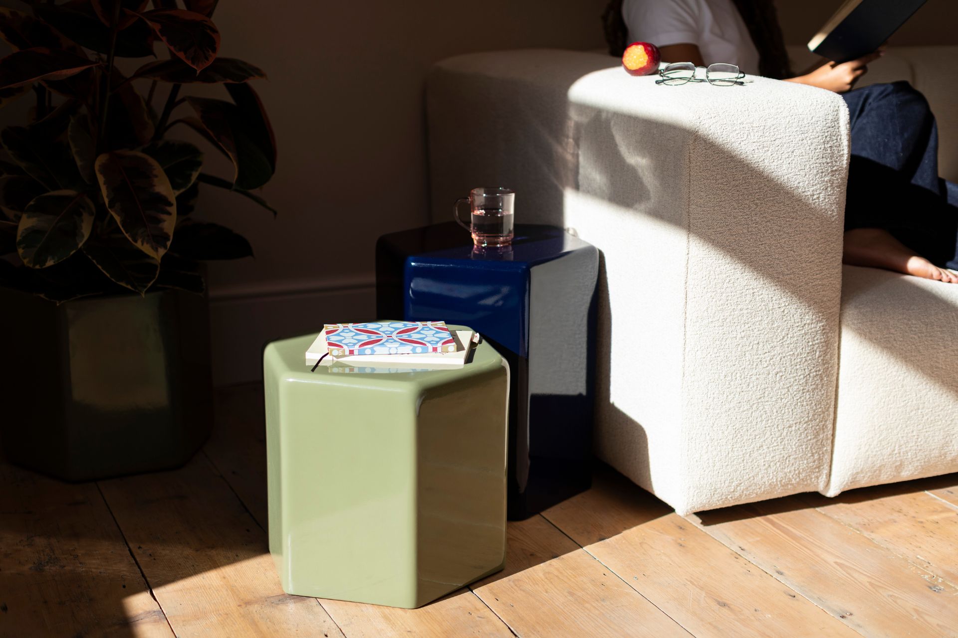 Living room with white sofa and olive green and navy blue arcylic hexagonal side tables