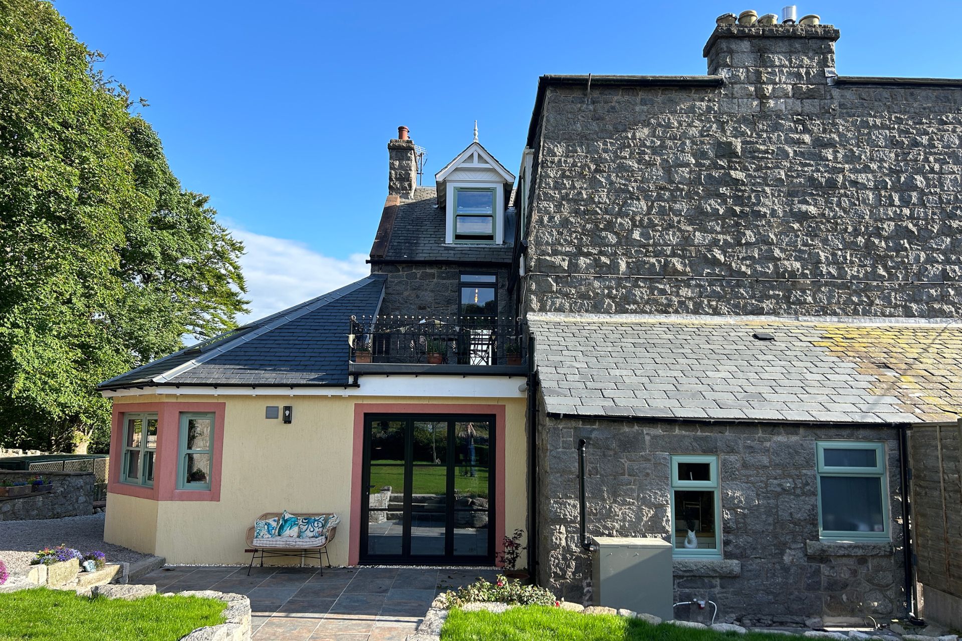 Stone cottage with white stone extension