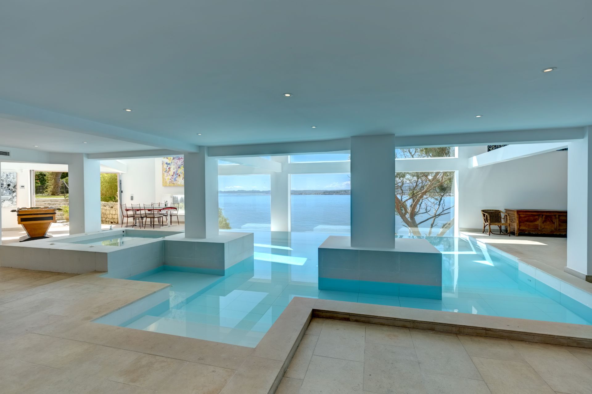 Indoor pool with stone columns and floor-to-ceiling windows