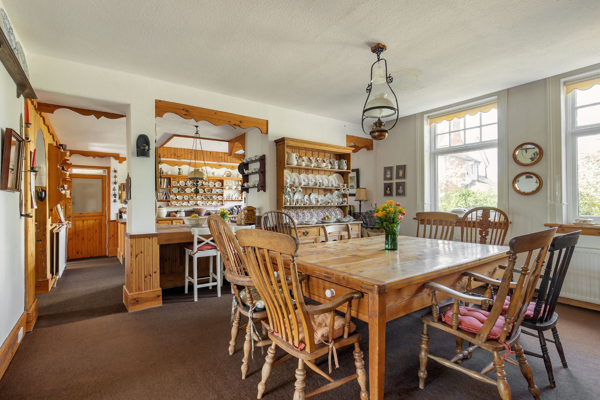 Kitchen with oak furniture and porcelain displayed on oak shelves