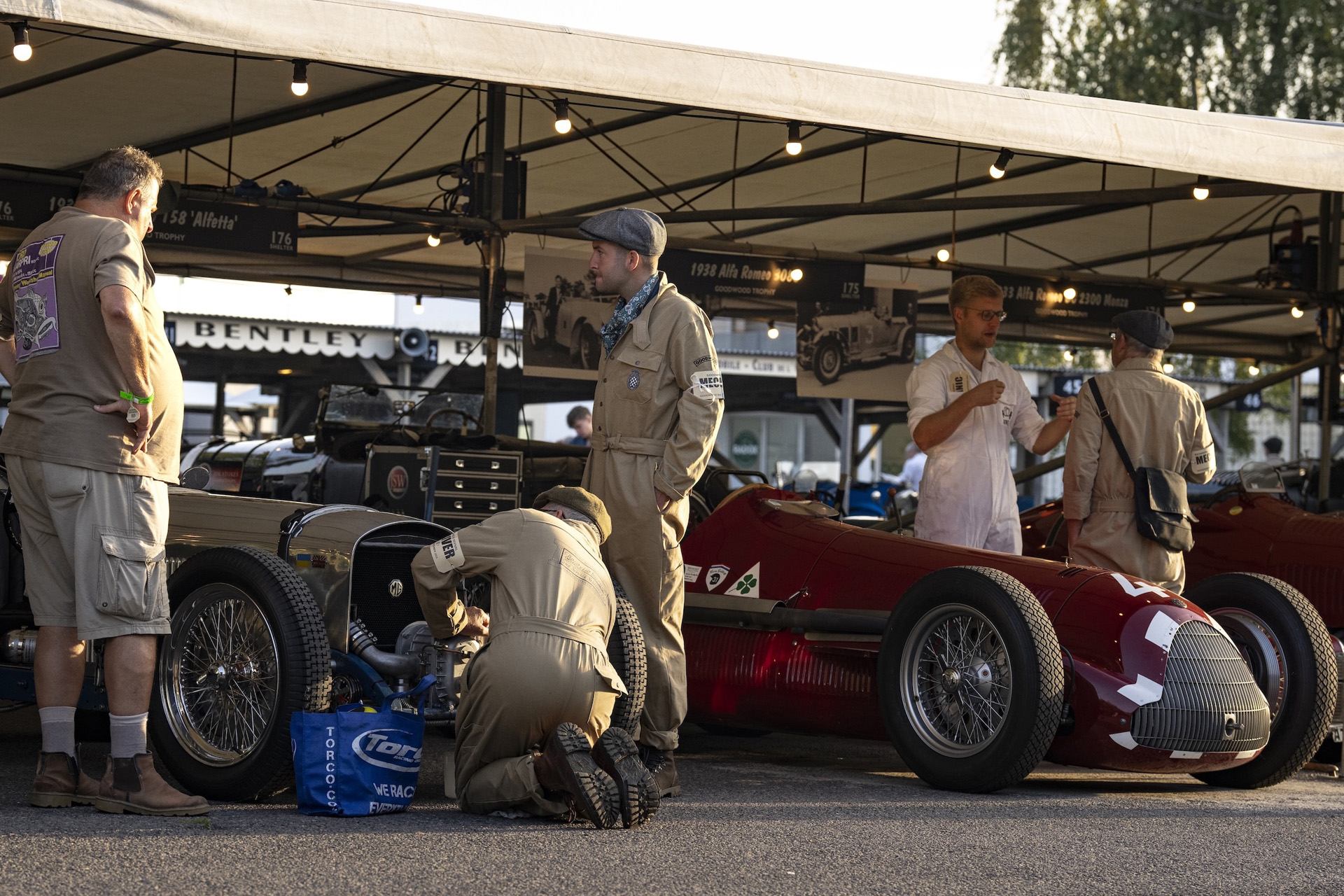 Mechanics working on a vintage car at Goodwood Revival