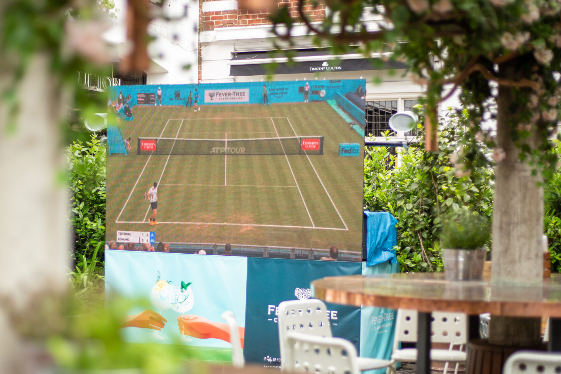 A large screen showing tennis
