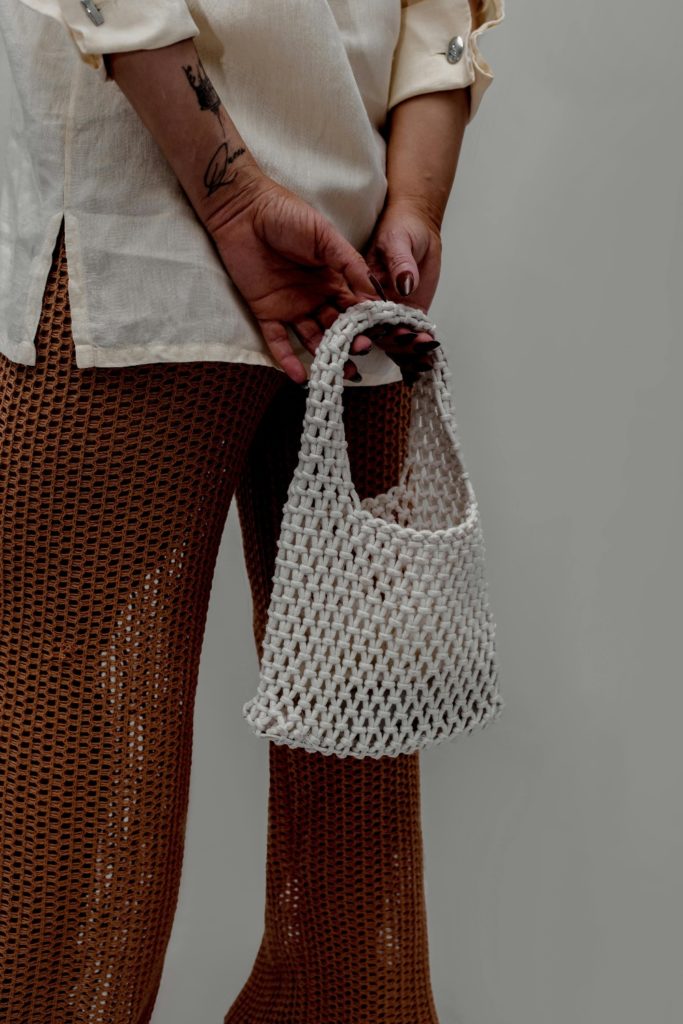 Person holding woven bag