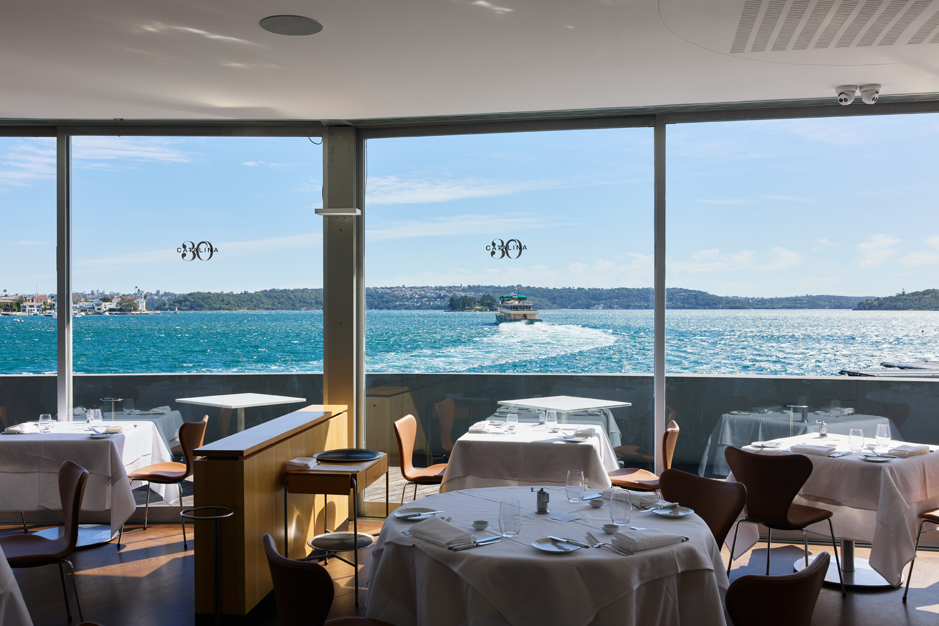 A restaurant with panoramic windows overlooking the water
