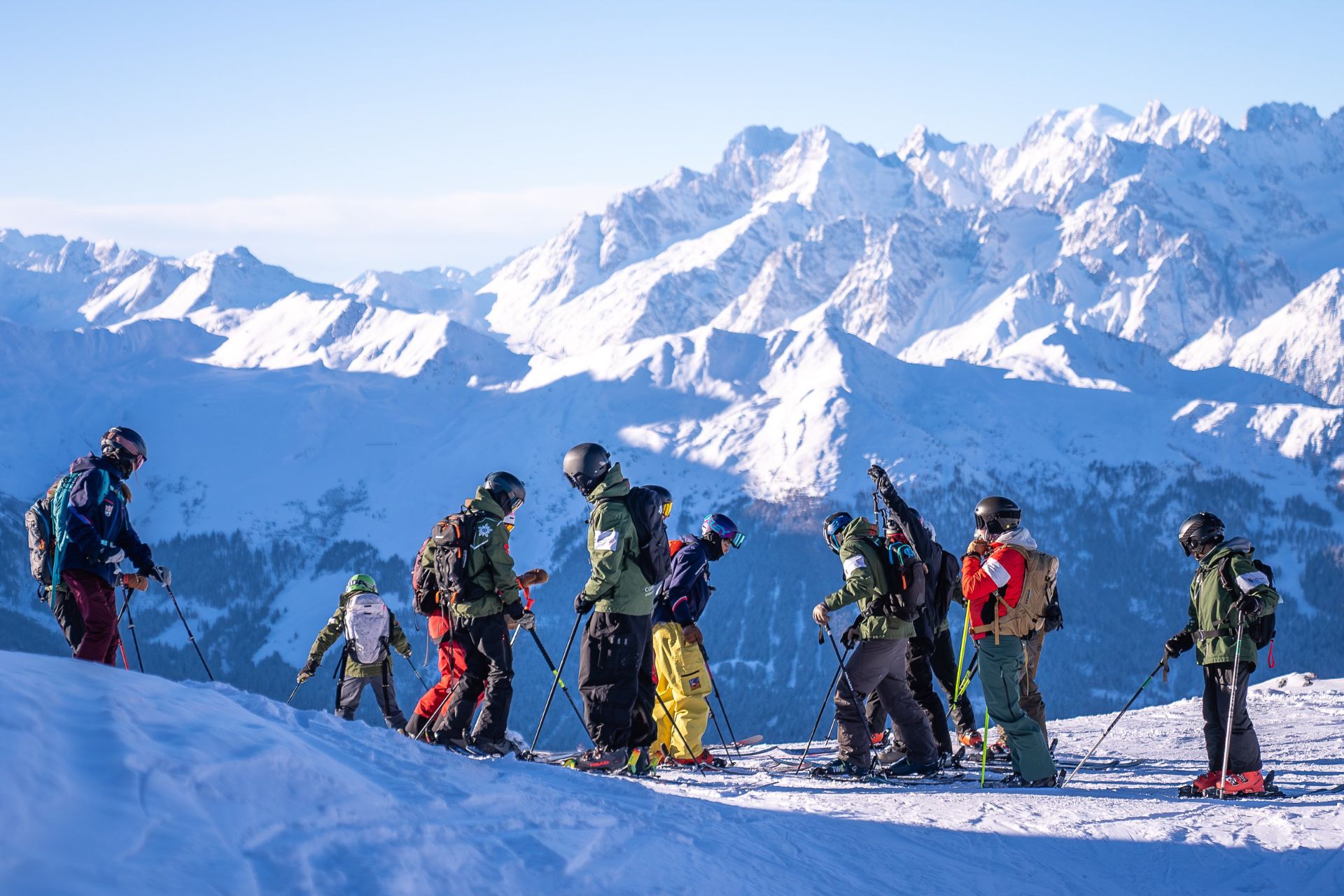 Students in ski gear in front of the alps
