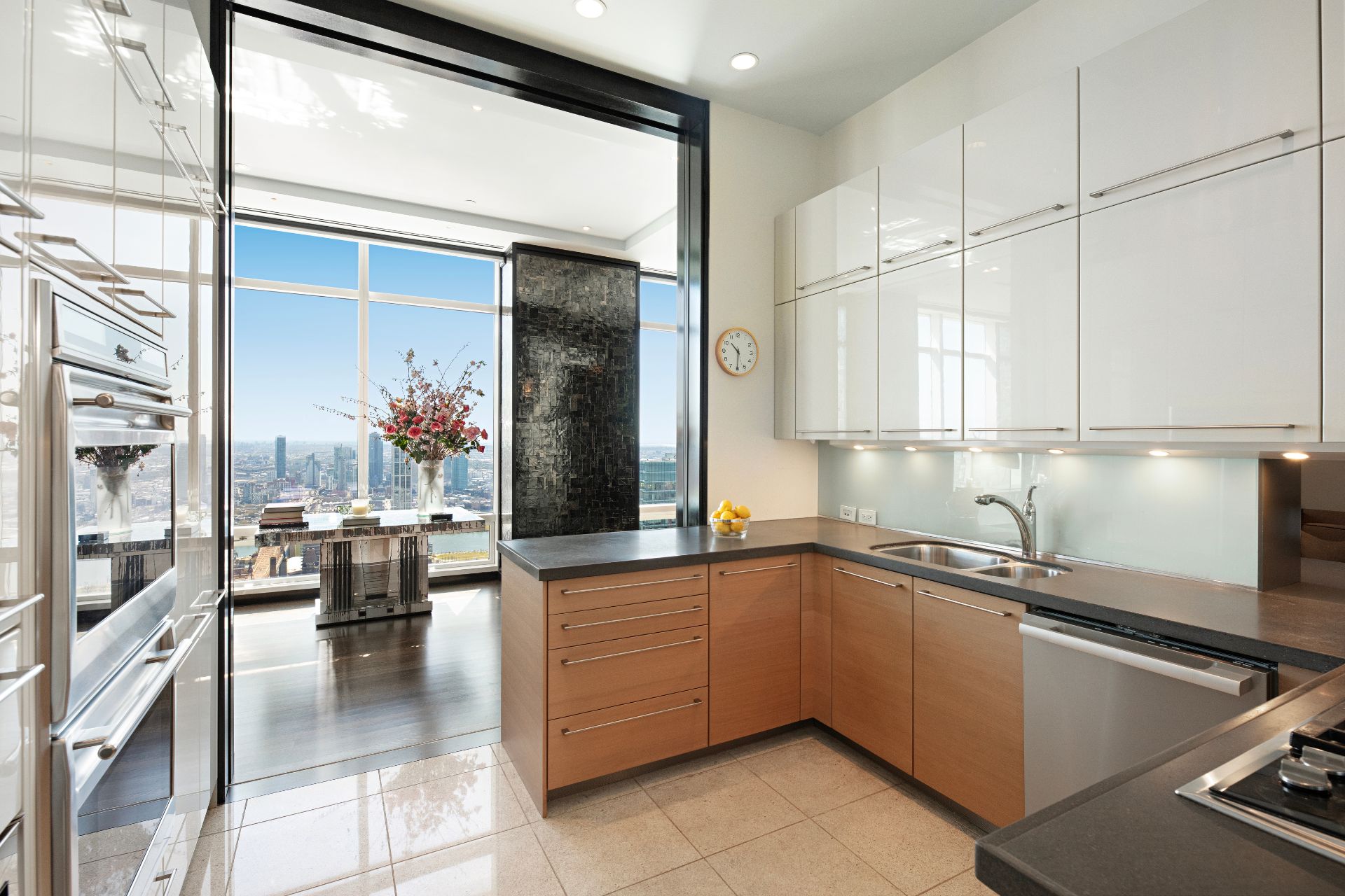 Modern kitchen with wooden cabinets and views of the New York skyline