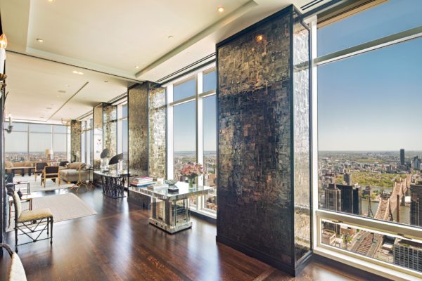 NYC penthouse with stone columns, wooden floors and floor-to-ceiling windows