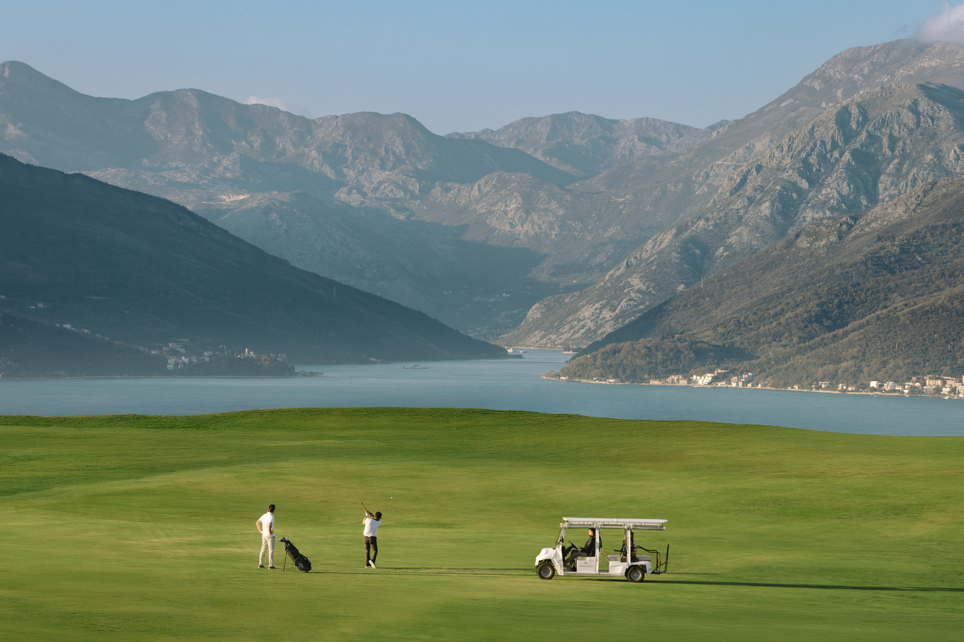 A golf course with mountains in the distance