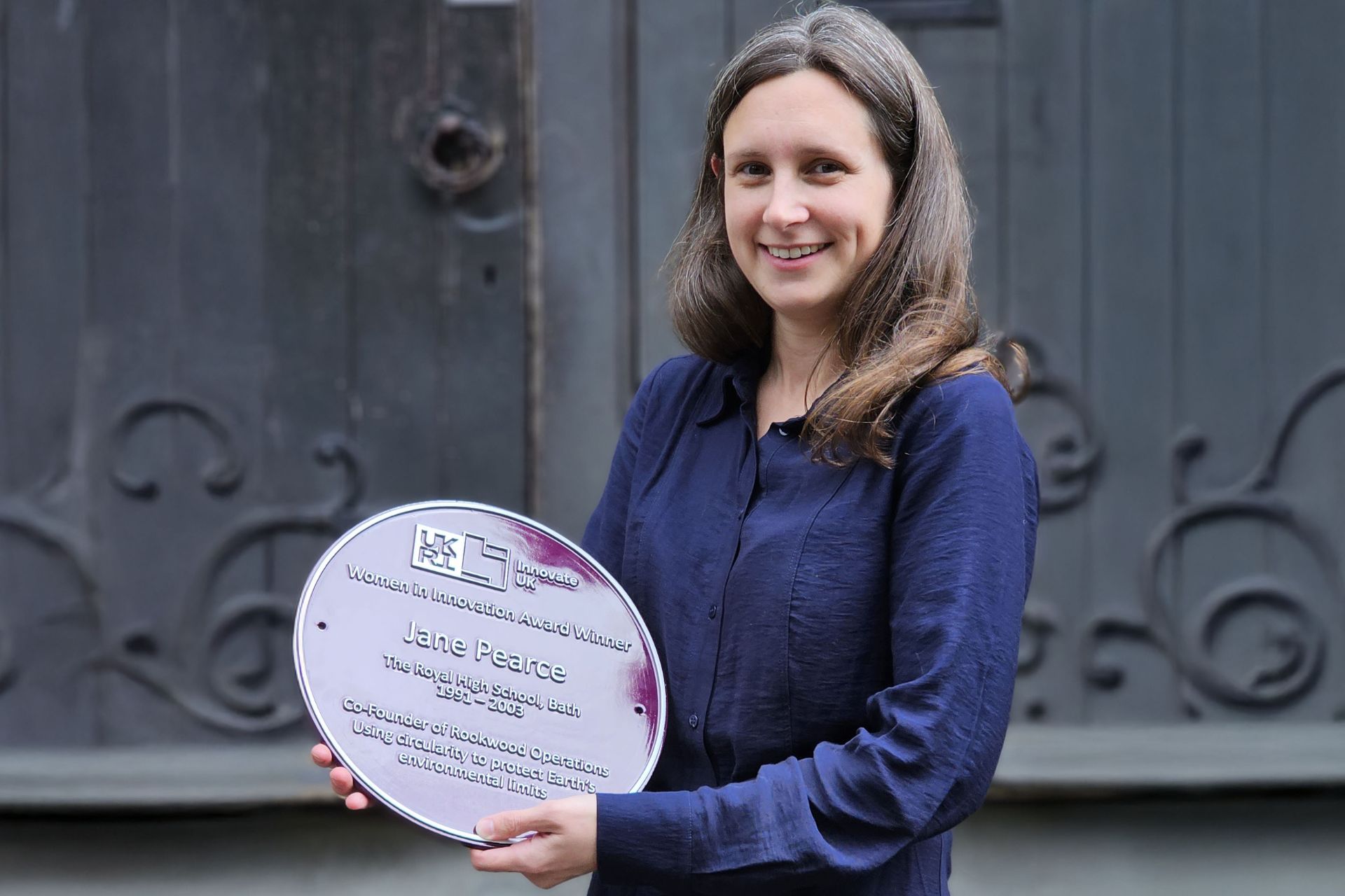 Jane Pearce poses with her purple plaque