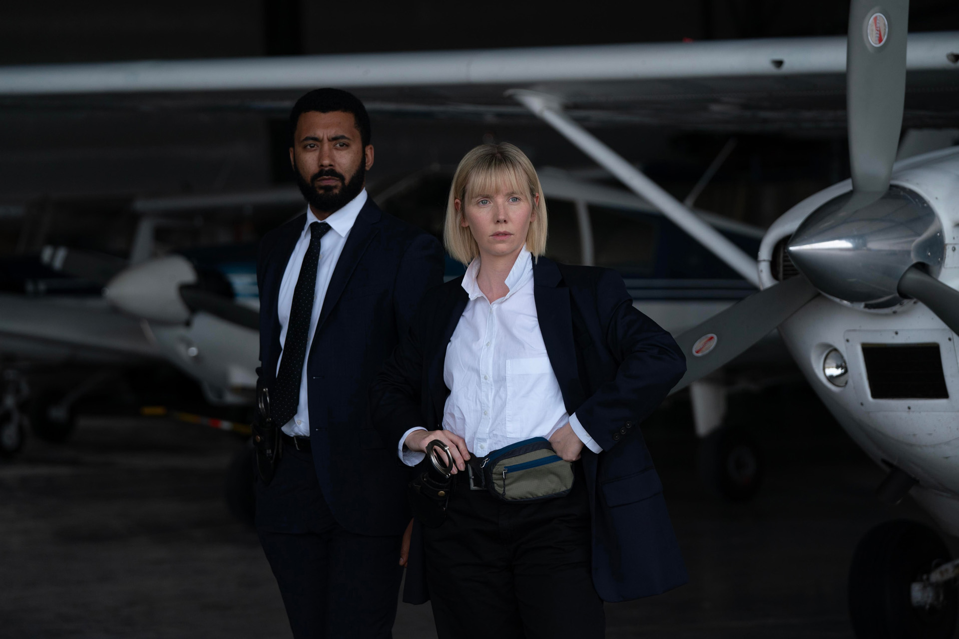 ZACH WYATT as Phil Parhatka and LAUREN LYLE as Karen Pirie