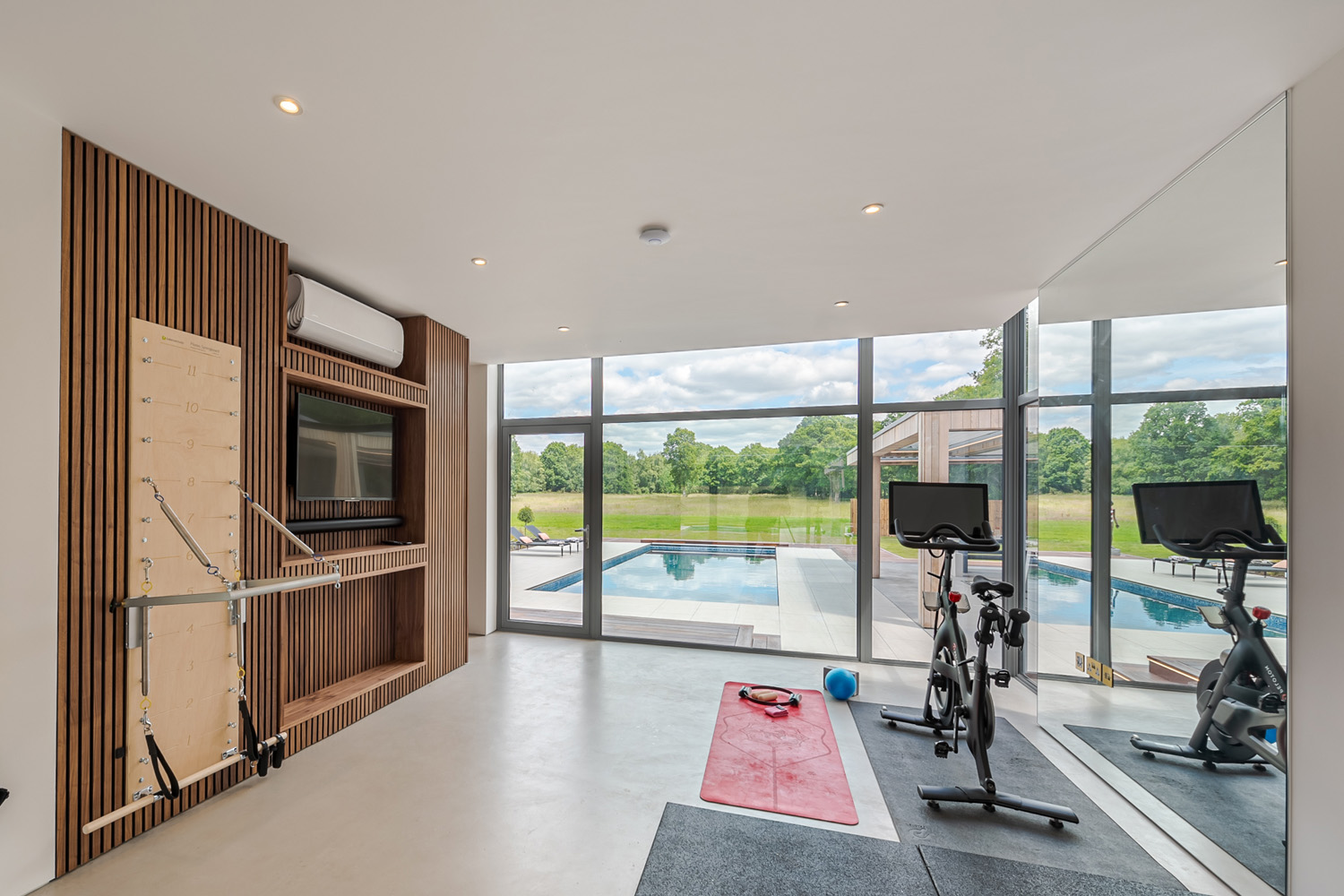 Stationary bikes overlooking a swimming pool