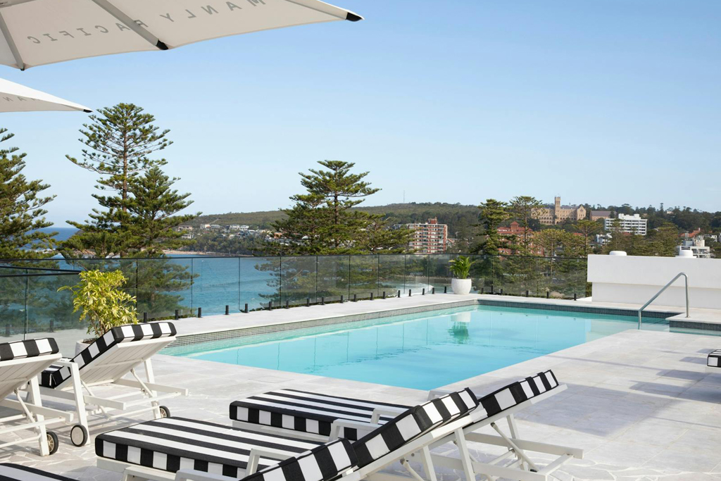 Loungers beside a small outdoor swimming pool