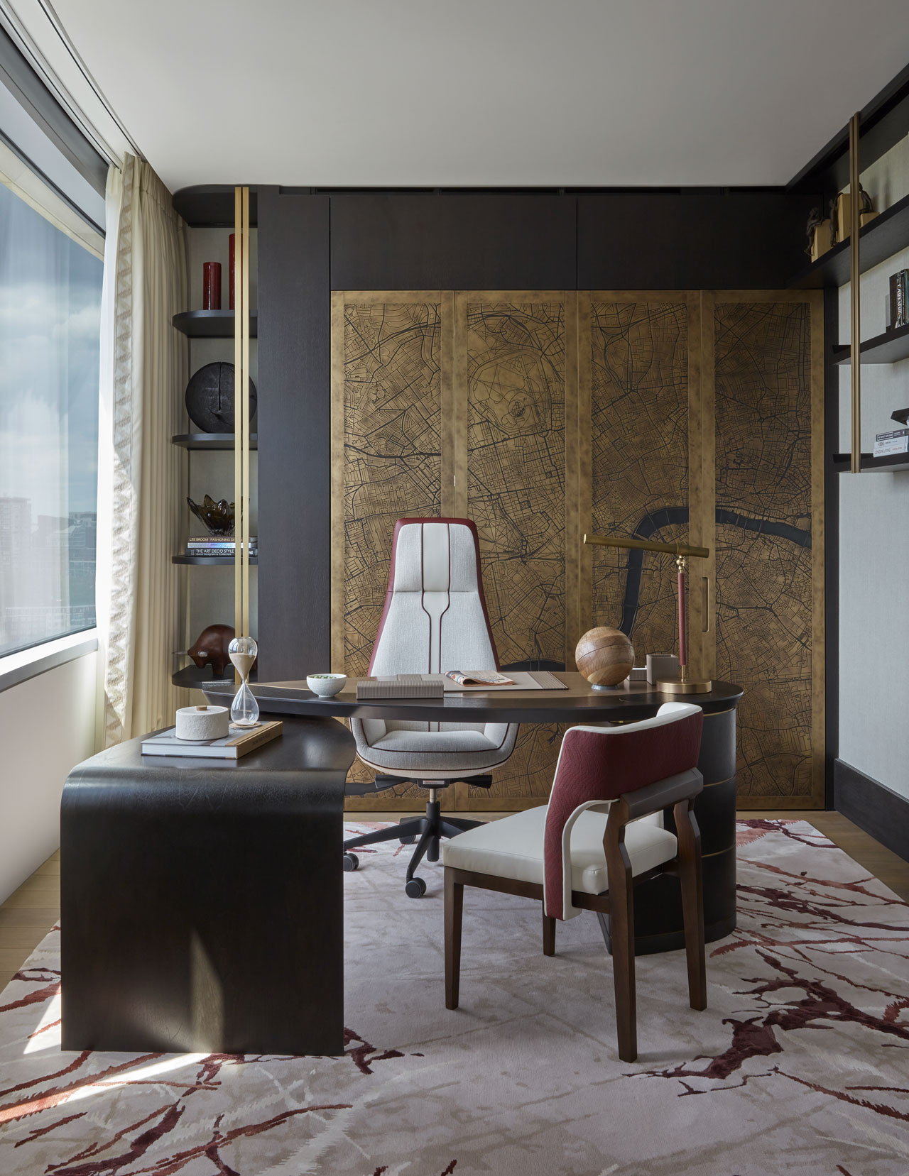 Study room with tall white swivel chair and desk. There is also a wooden chair in front of the desk. The wall behind is gold and decorative