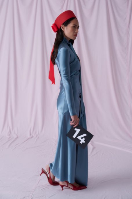 Woman in blue dress and red hat