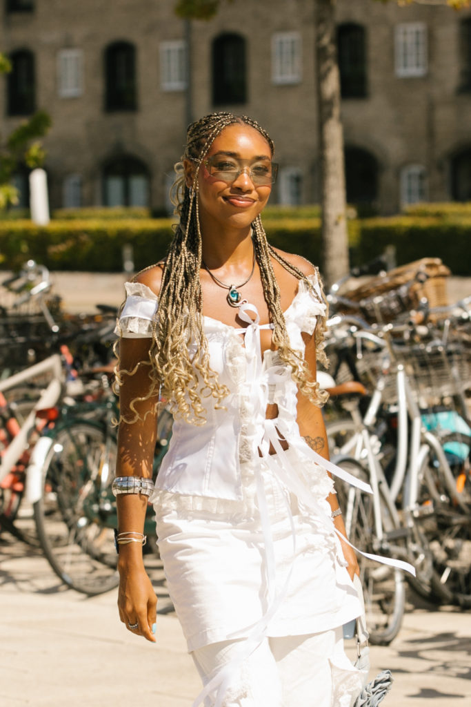 Woman wearing white | summer hair trends 2025