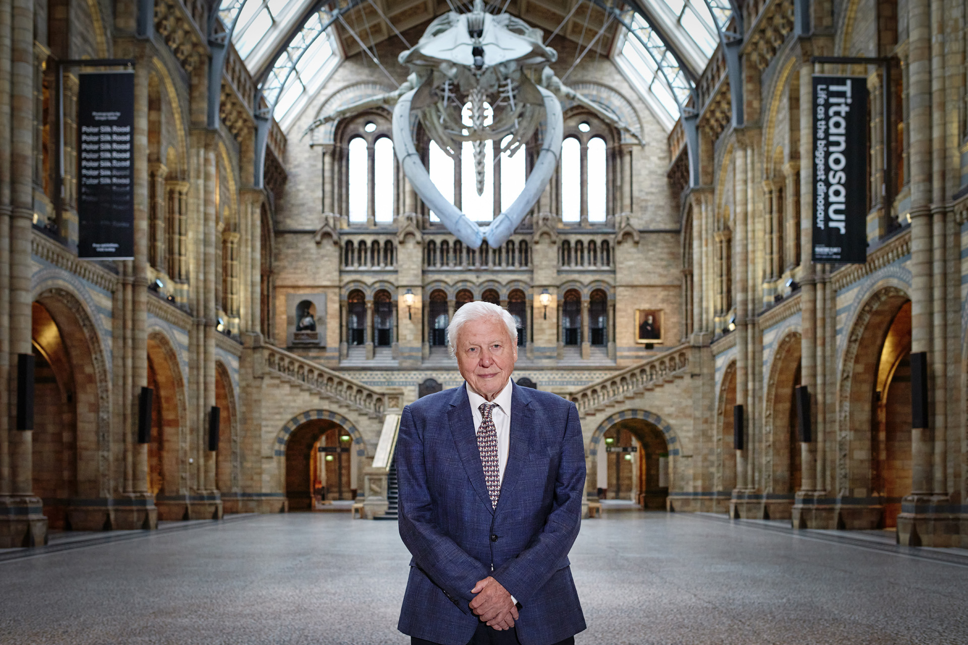 Sir David Attenborough beneath Hope the Blue Whale at the Natural History Museum.