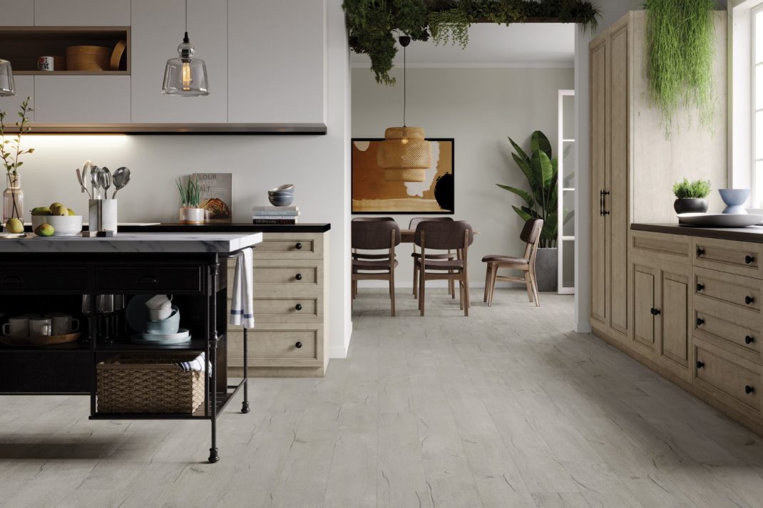 Kitchen with white wooden floors and vines trailing from the ceiling