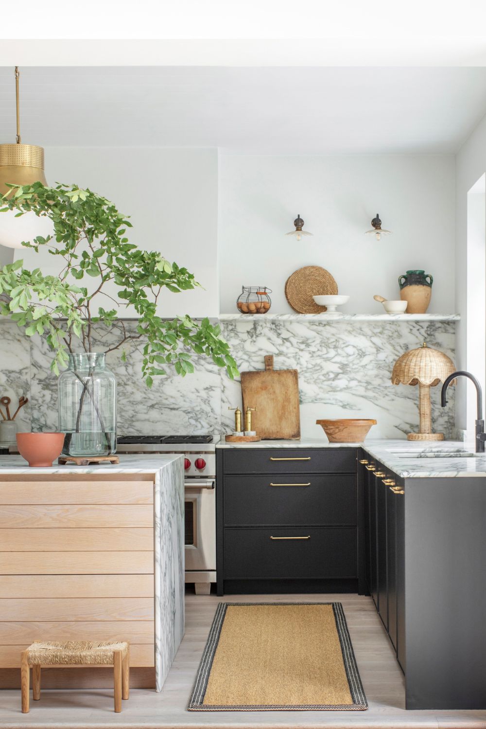 Kitchen with black cabinets and white worktops