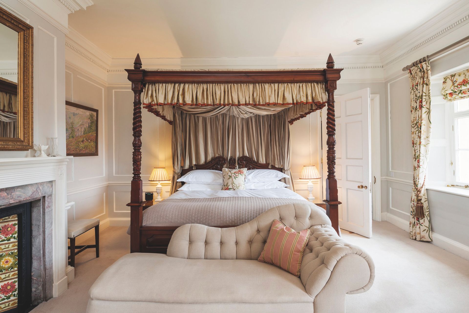 Bedroom with four poster bed and cream chaise longue