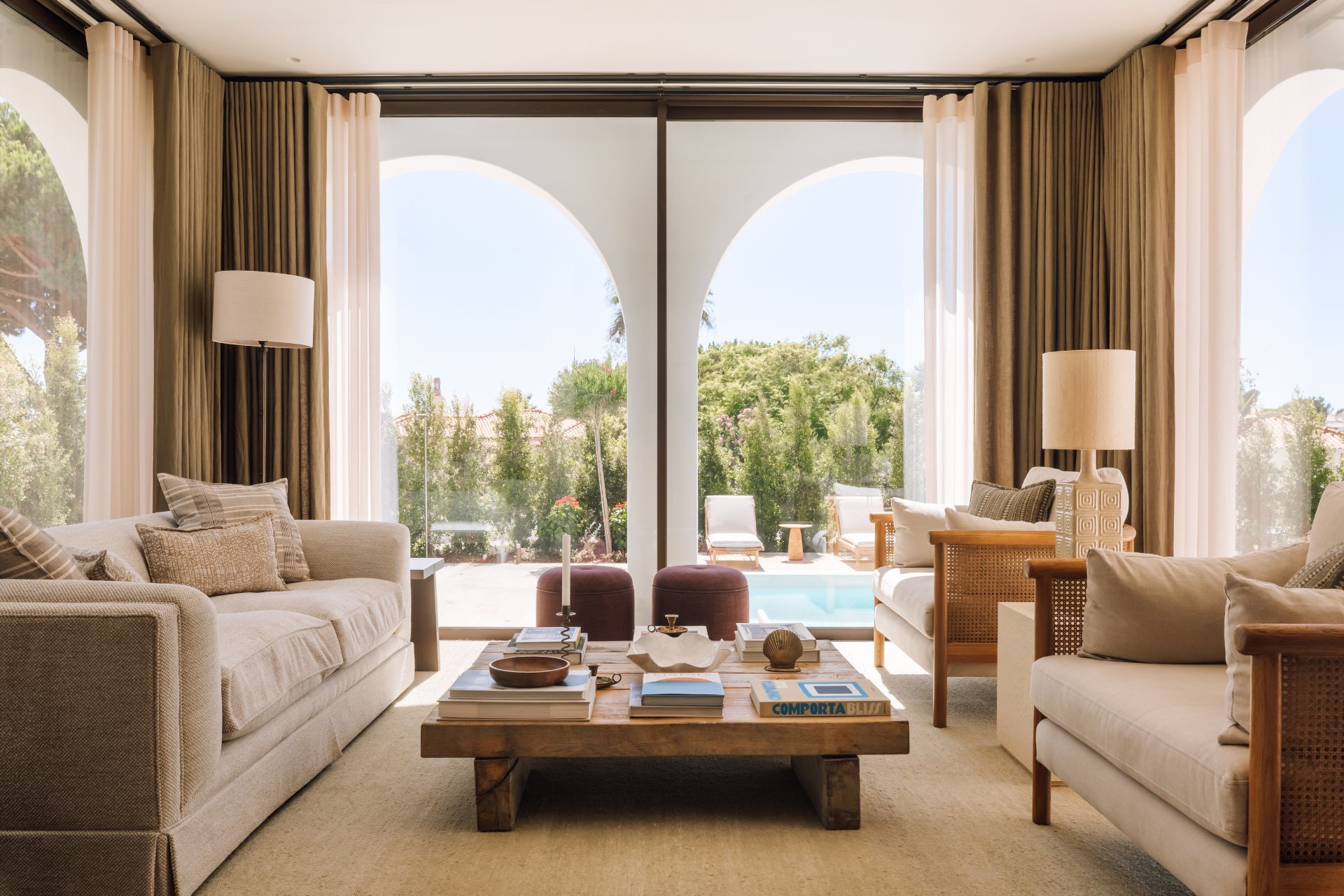 Living area with floor-to-ceiling windows, cream sofas and a jute rug