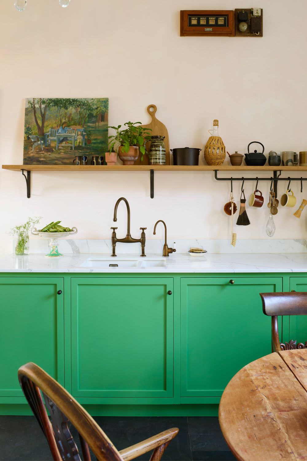 Kitchen with avocado green cabinets and white marble worktops