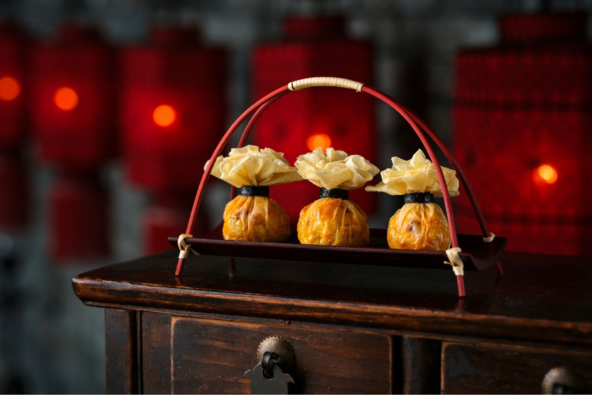 Three dumplings on a wooden platter