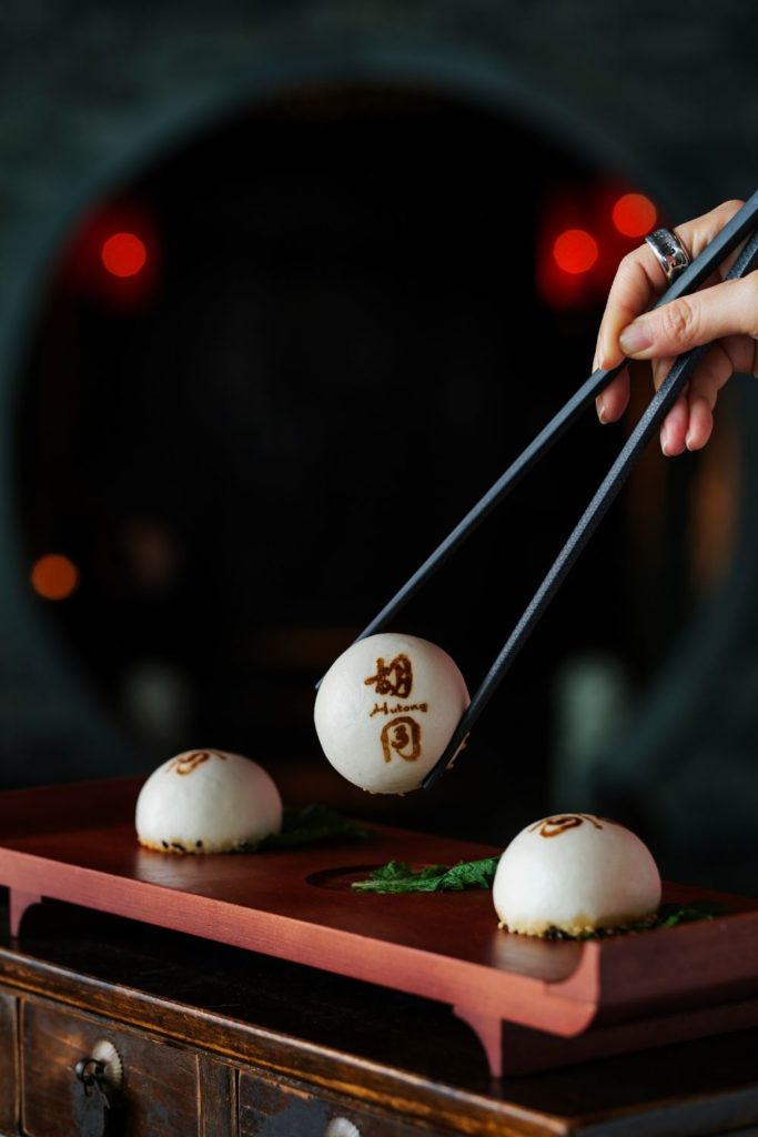 Hutong branded dumplings on a wooden platter