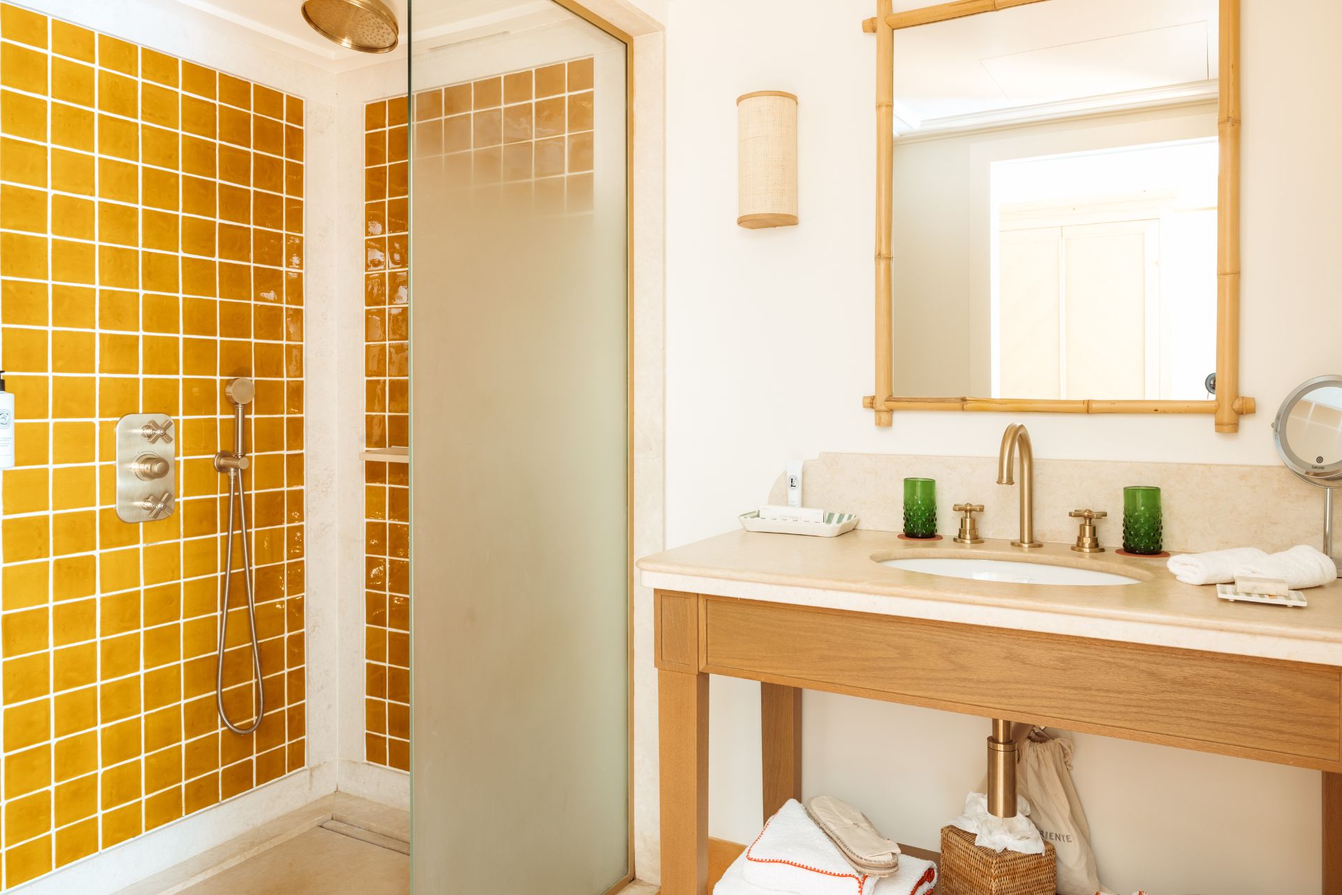 Bathroom with mustard yellow tiles and white marble surfaces