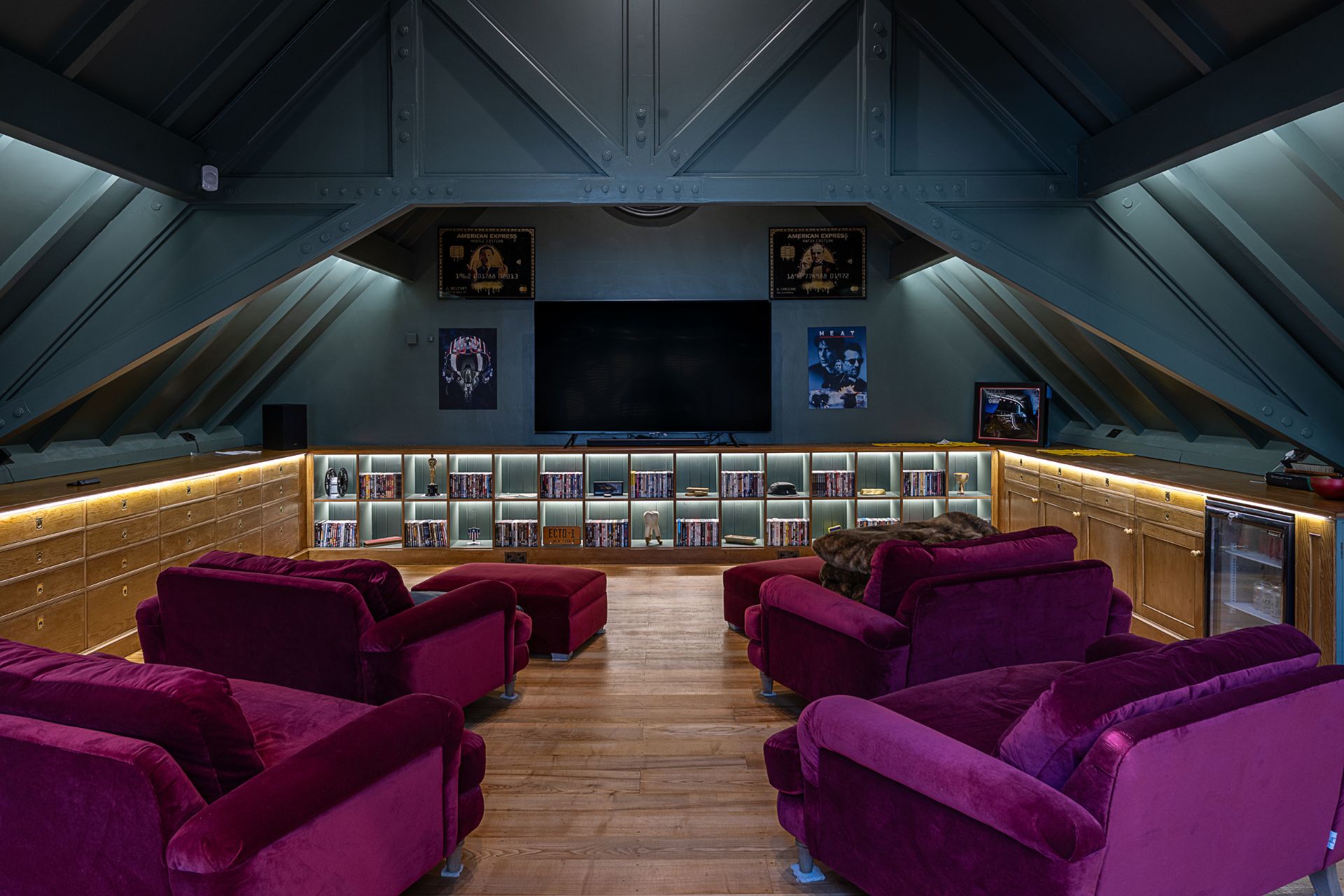 Vaulted cinema room with deep purple velvet armchairs