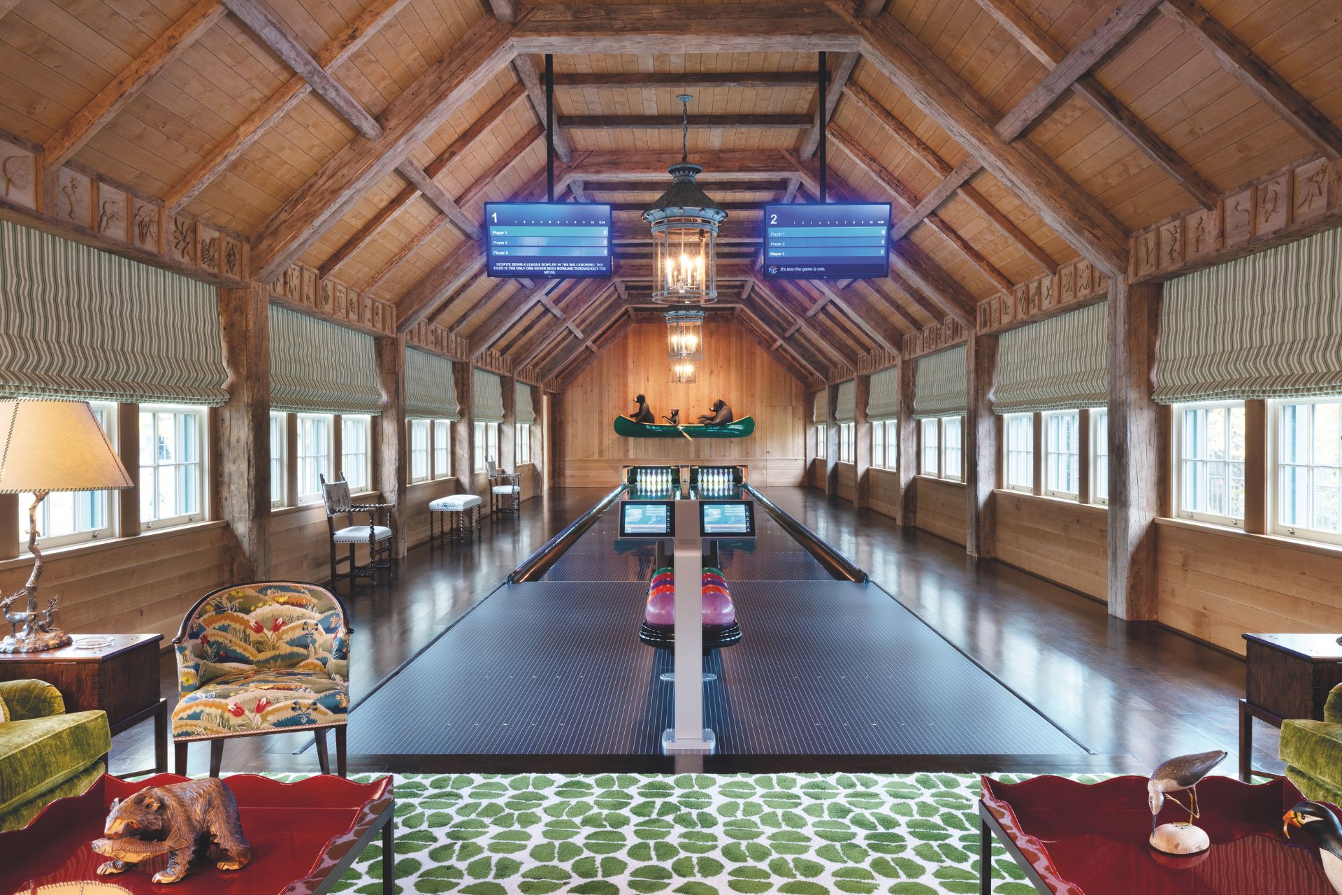 Bowling alley in private home with vaulted wooden ceiling and green and white rug