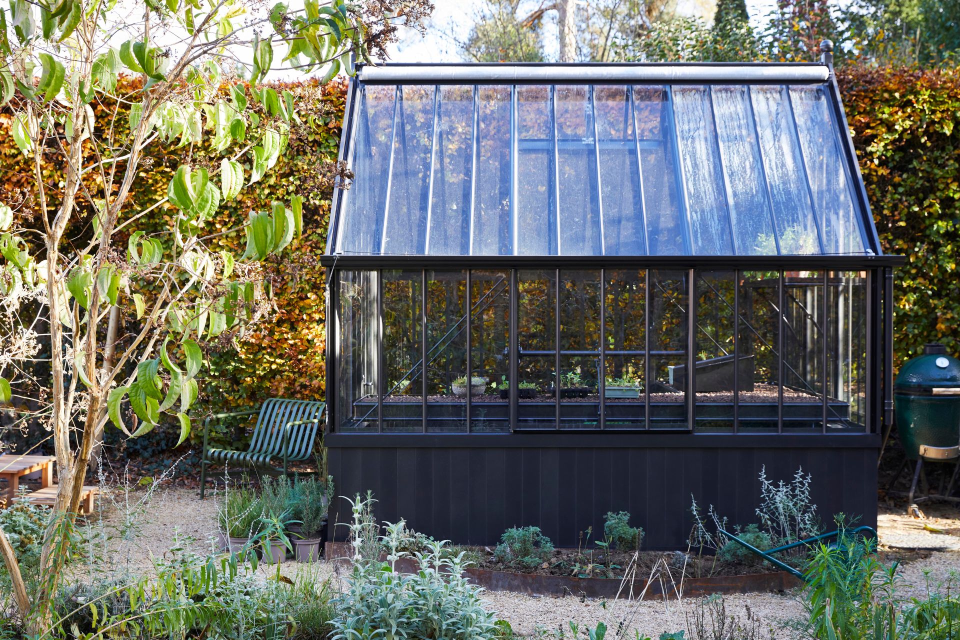 Side view of greenhouse with black timber frame
