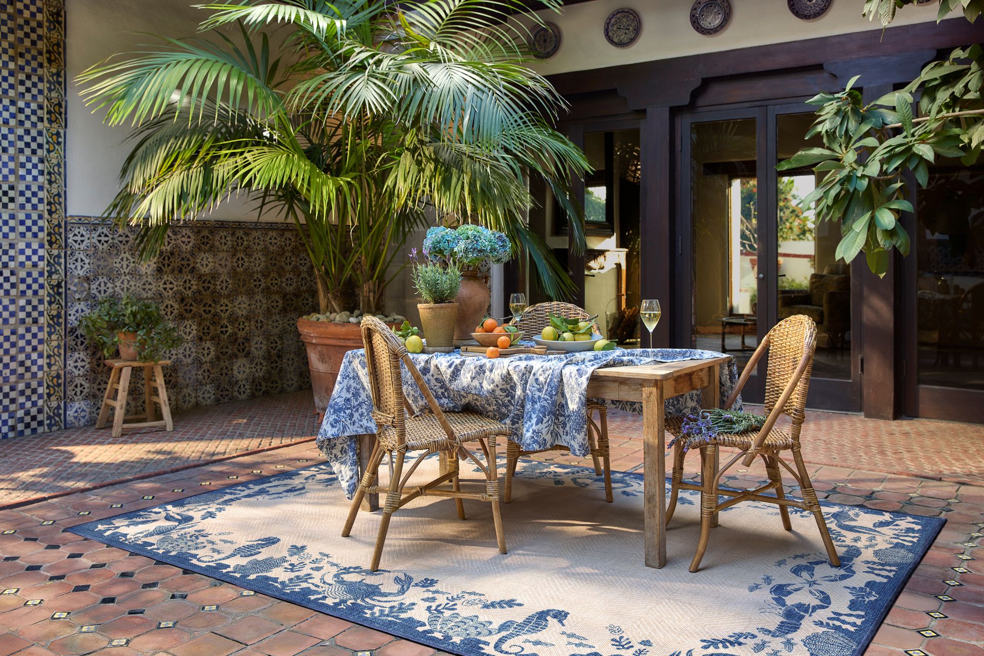 Garden patio with blue and white rug and matching table cloth
