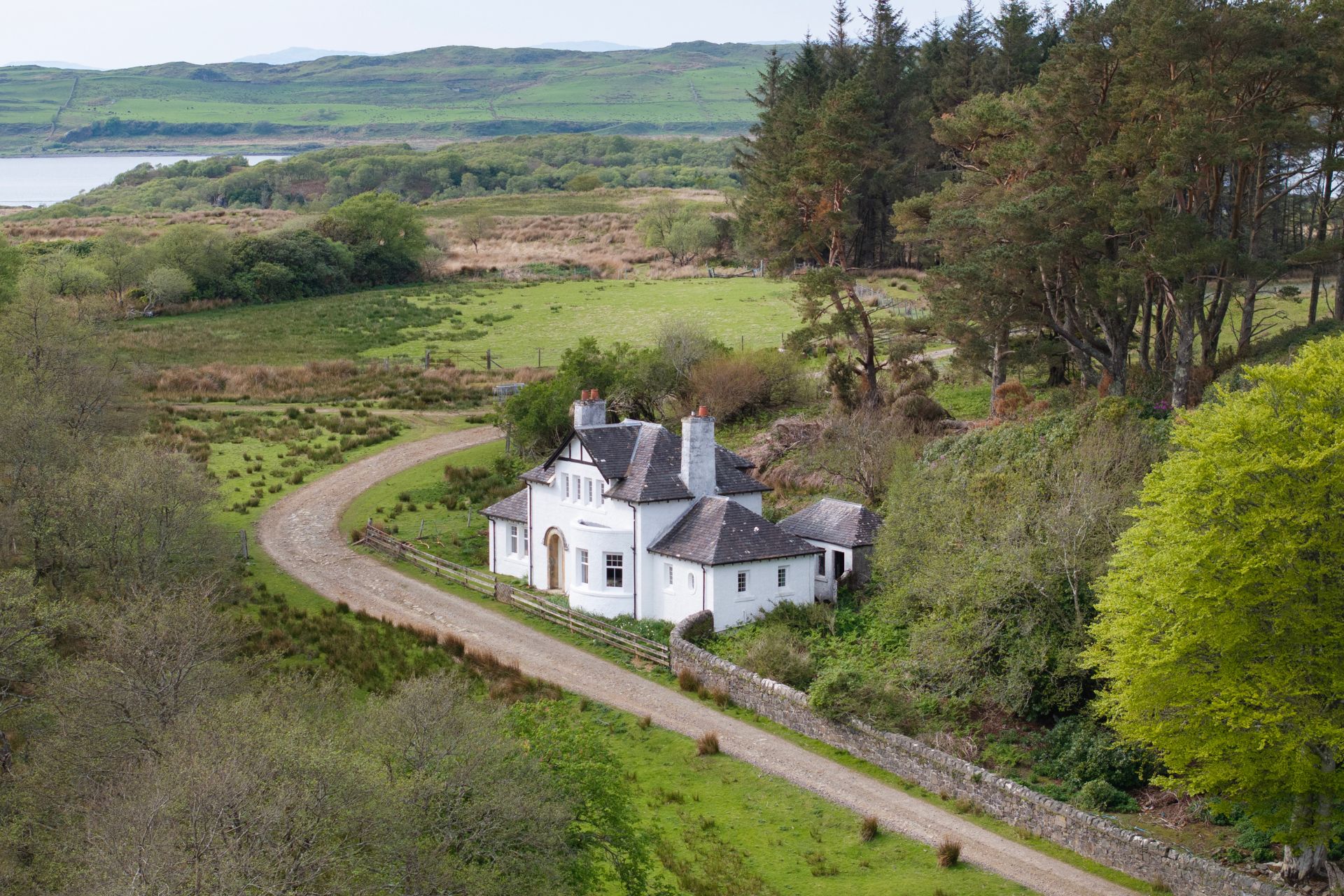 White stucco house on leafy Scottish island