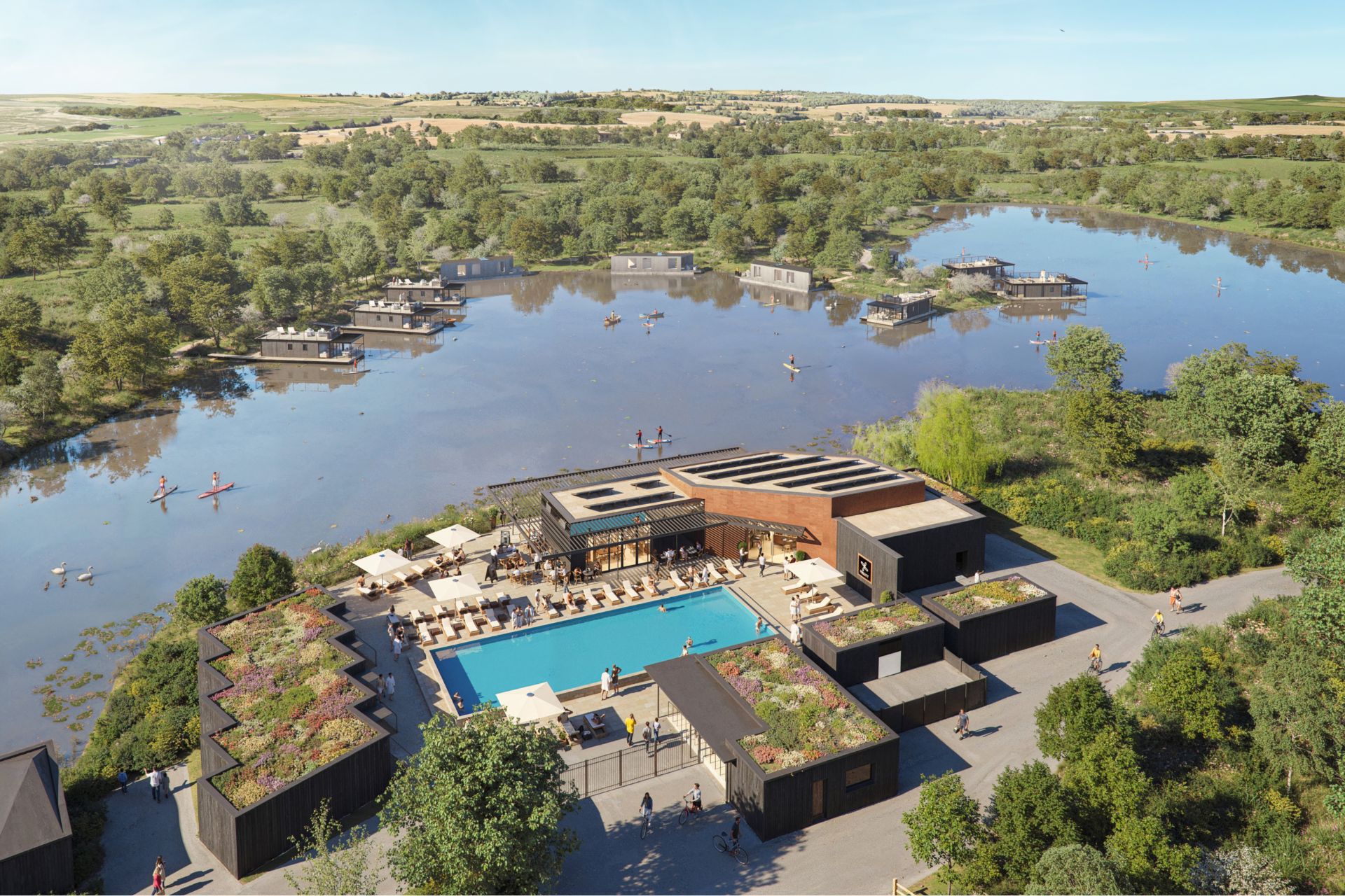 Aerial view of lakeside estate with houseboats and a central pool