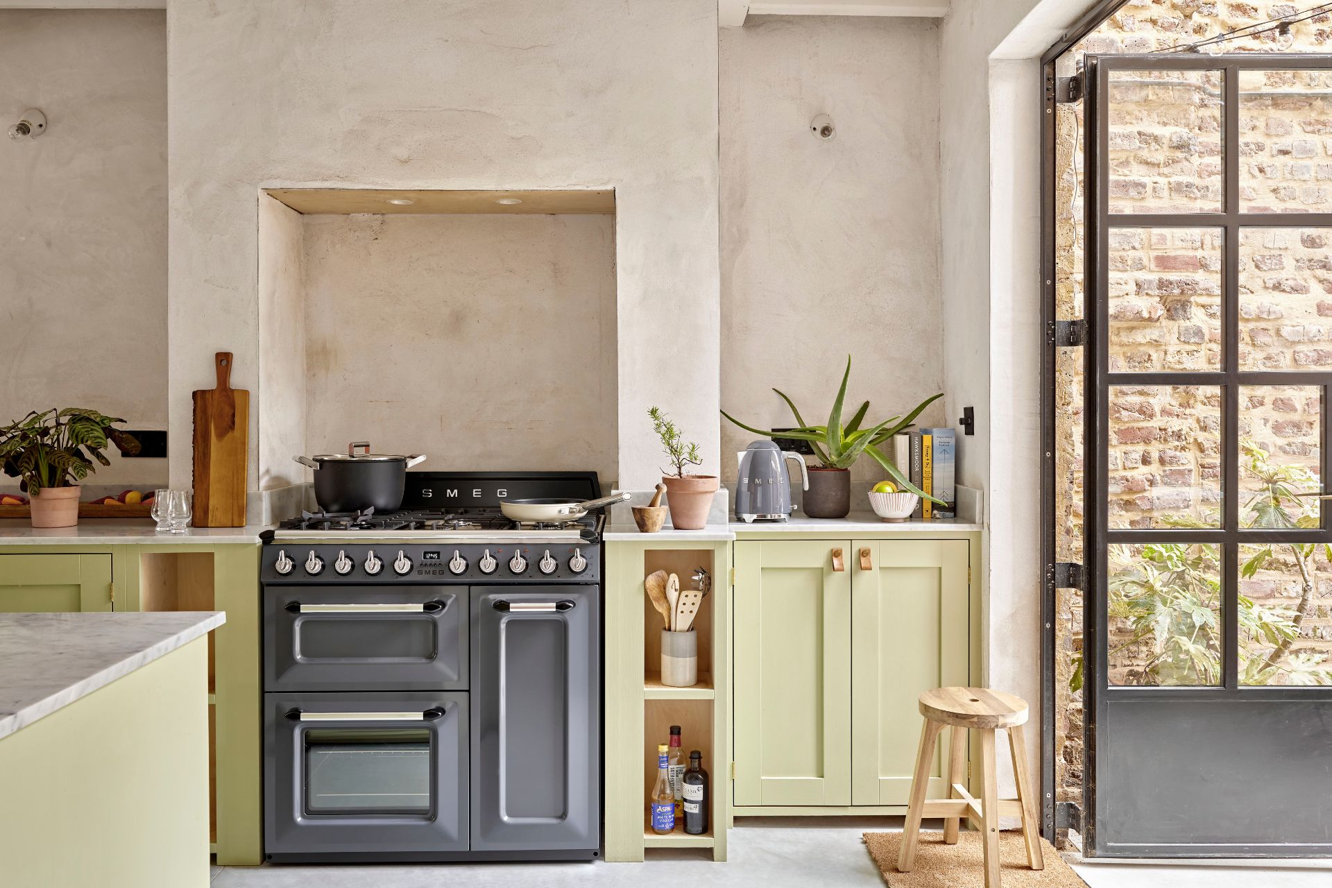 Kitchen with grey range cooker and pastel yellow cabinets